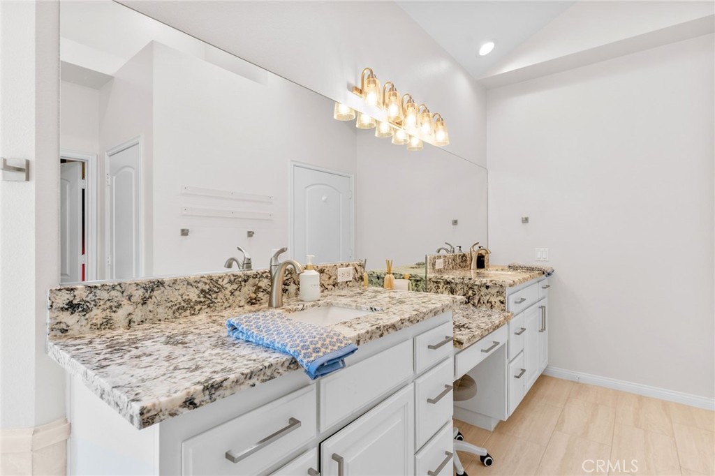 30702 Cll Pina Colada Temecula, CA 92591 - Photo 52 of 75 a bathroom with a granite countertop sink and a mirror