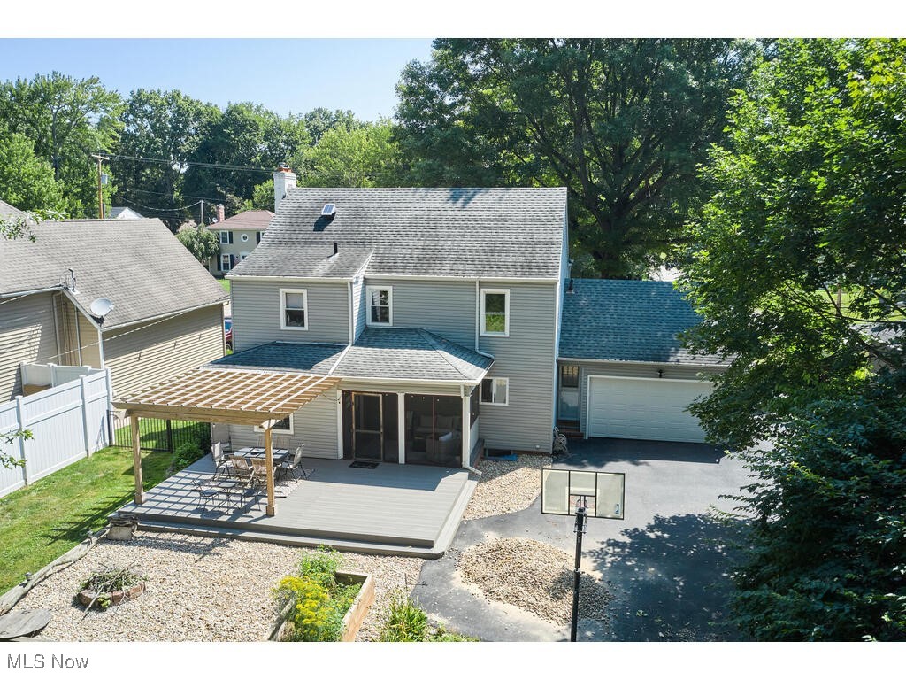 132 Sand Run Road Akron, OH 44313 - Photo 29 of 31 View of front of house featuring fence, aphalt driveway, a wooden deck, roof with shingles, and a garage