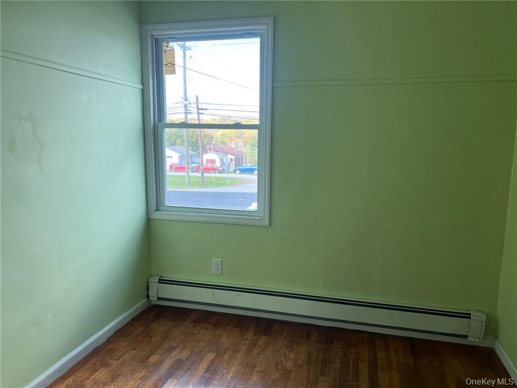 708 Silver Lake-Scotchtown Road Middletown, NY 10941 - Photo 18 of 25 Empty room featuring dark hardwood / wood-style floors and baseboard heating