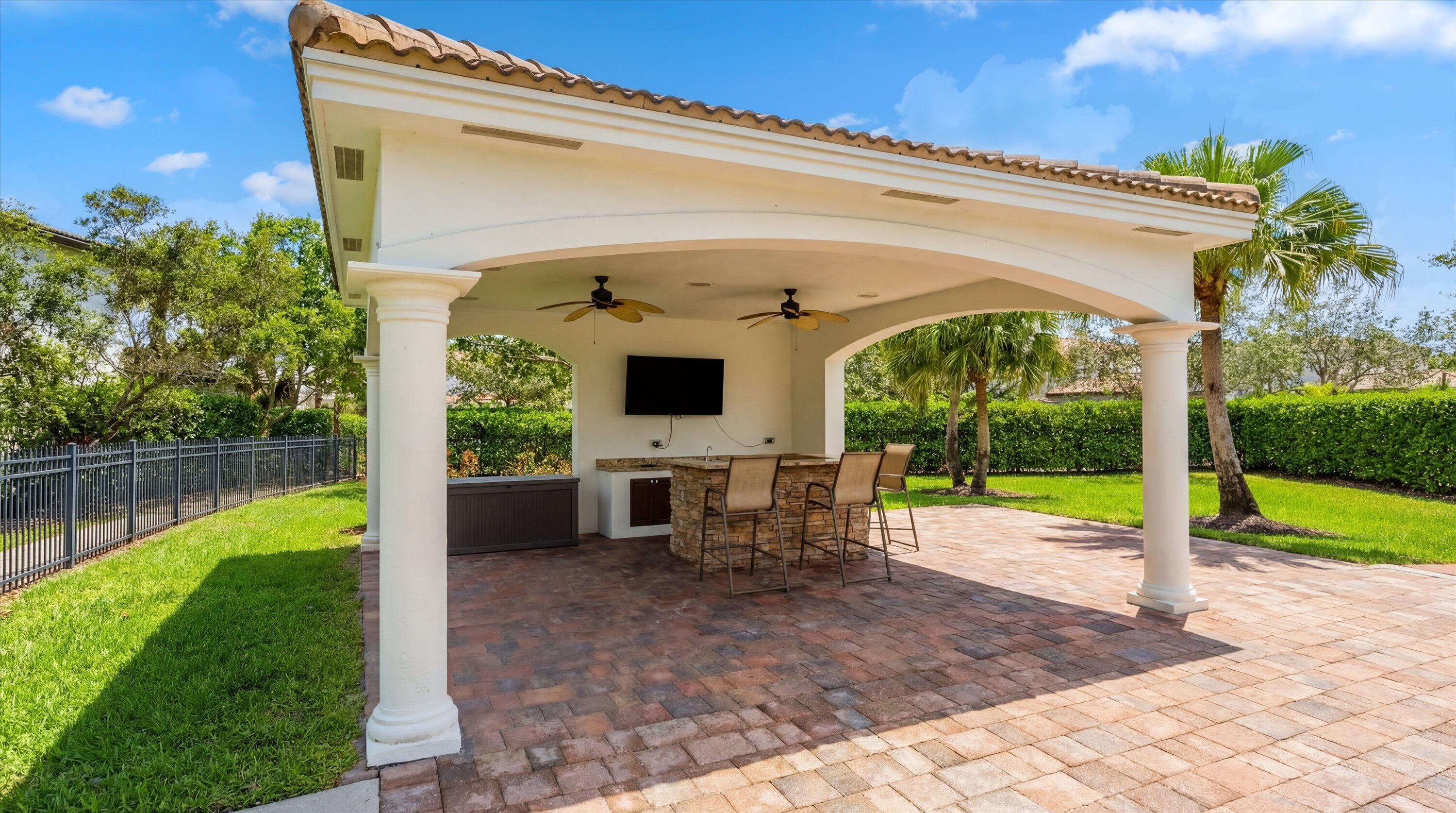 108 Casa Circle Jupiter, FL 33458 - Photo 46 of 53 a view of a swimming pool with a patio and a yard