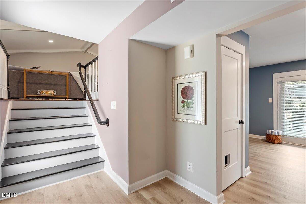 2120 Hillock Drive Raleigh, NC 27612 - Photo 5 of 29 a view of a hallway with entryway wooden floor and stairs