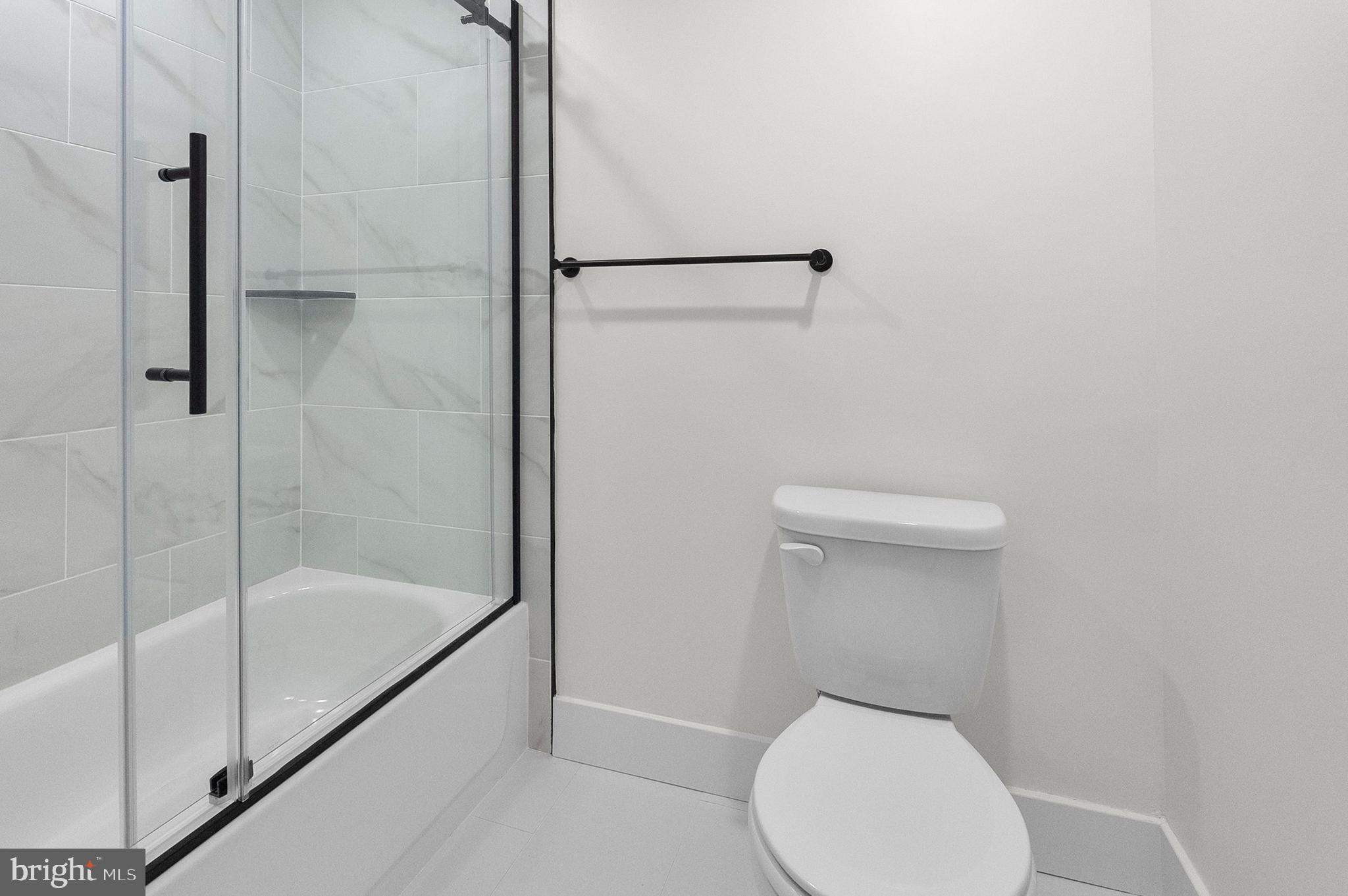 2200 East Fayette Street Baltimore, MD 21231 - Photo 14 of 23 a white toilet sitting next to a shower