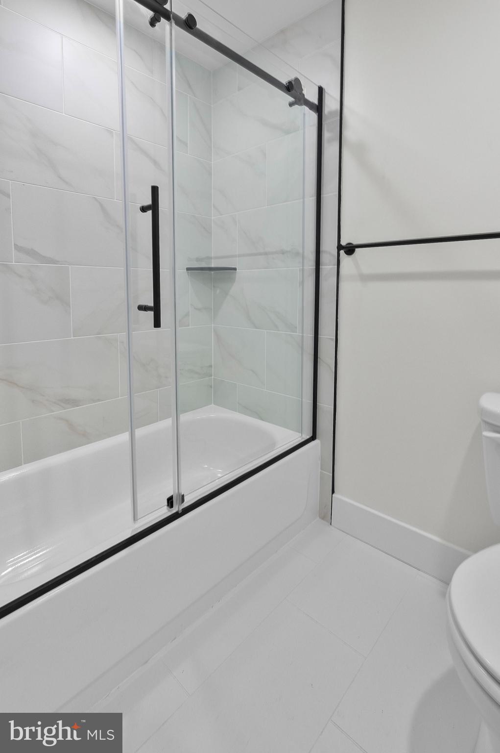 2200 East Fayette Street Baltimore, MD 21231 - Photo 15 of 23 a bathroom with a shower and a toilet