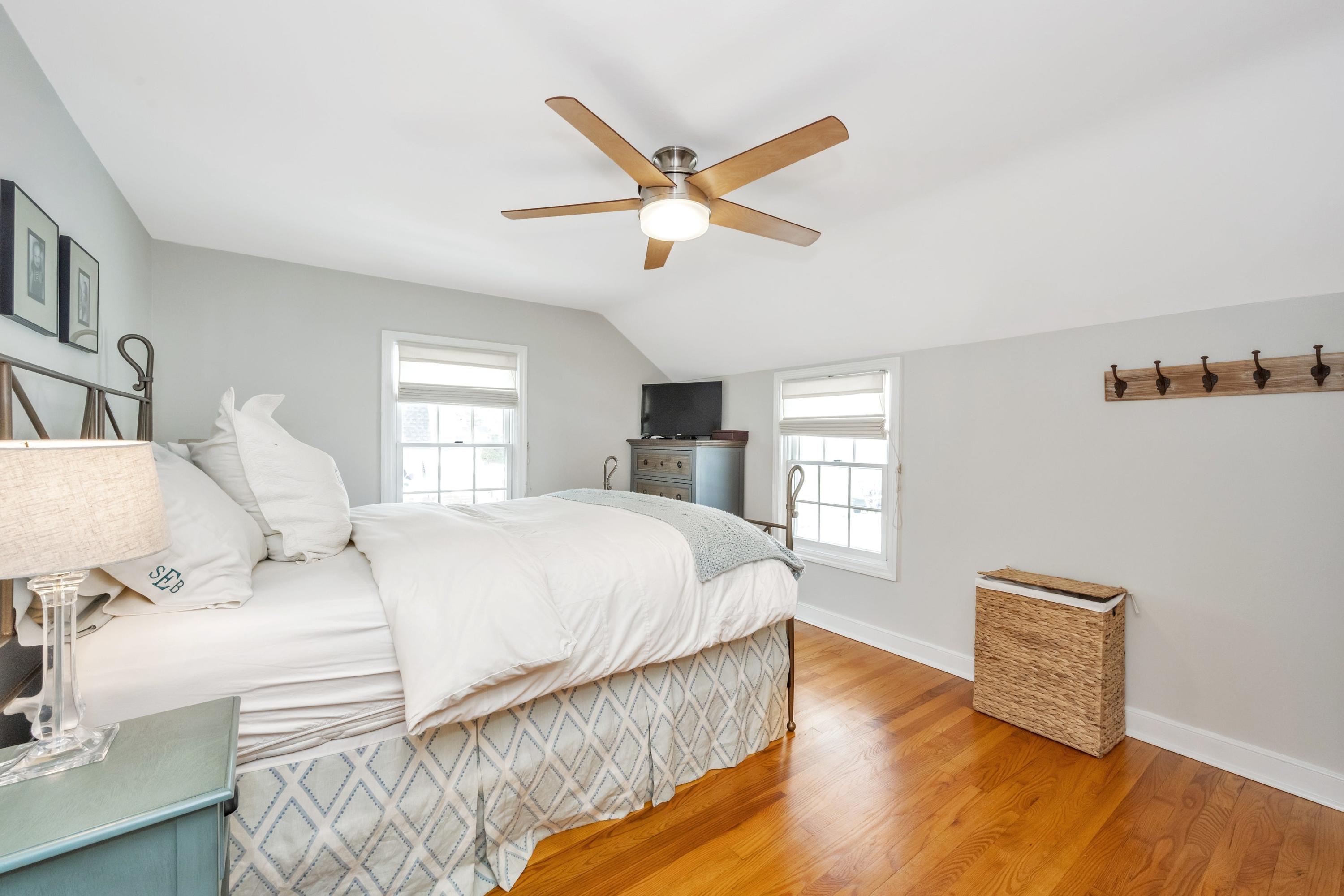 879 Oldfield Road Fairfield, CT 06824 - Photo 11 of 26 a bedroom with a bed and wooden floor