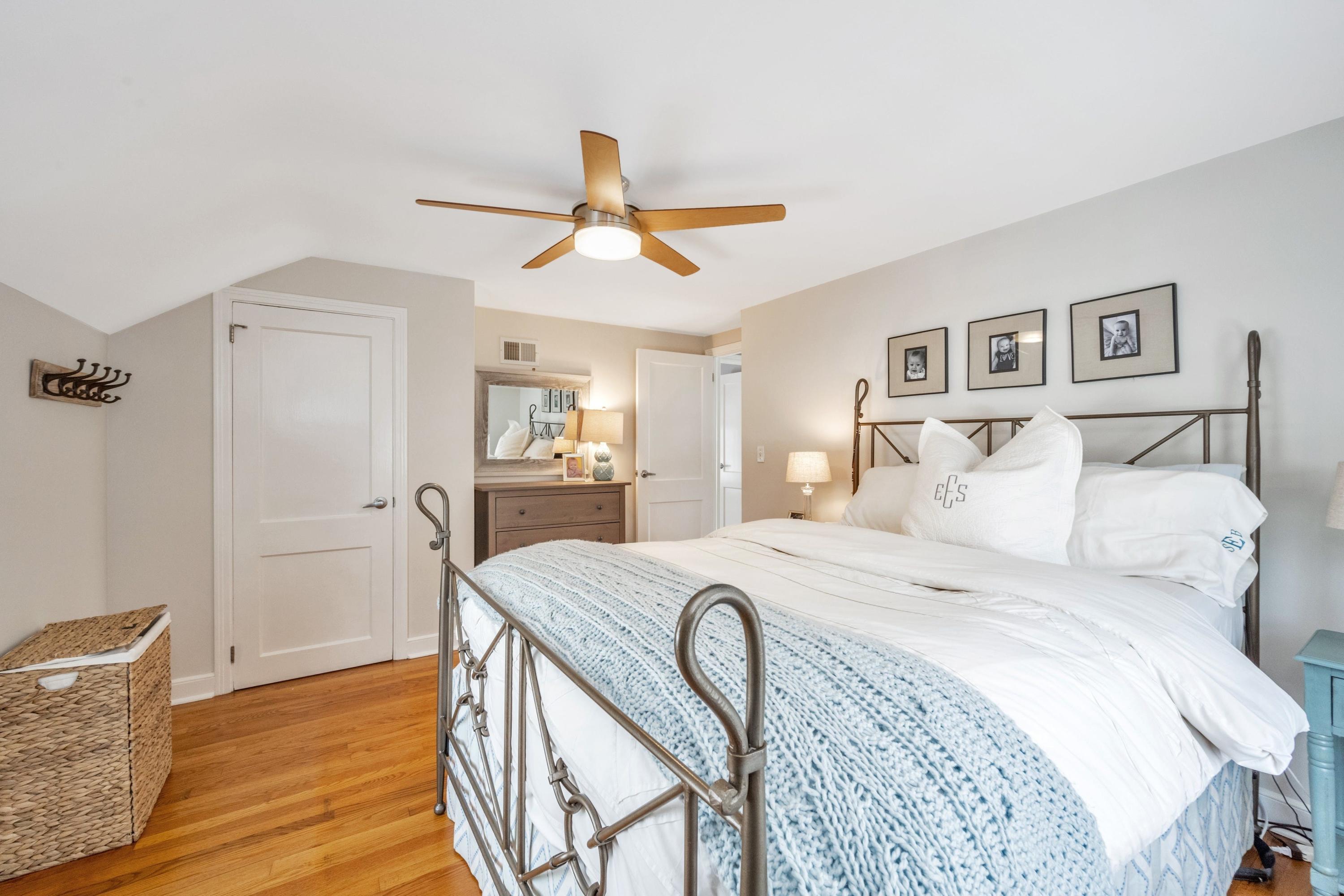 879 Oldfield Road Fairfield, CT 06824 - Photo 12 of 26 a bed room with a bed and a chandelier