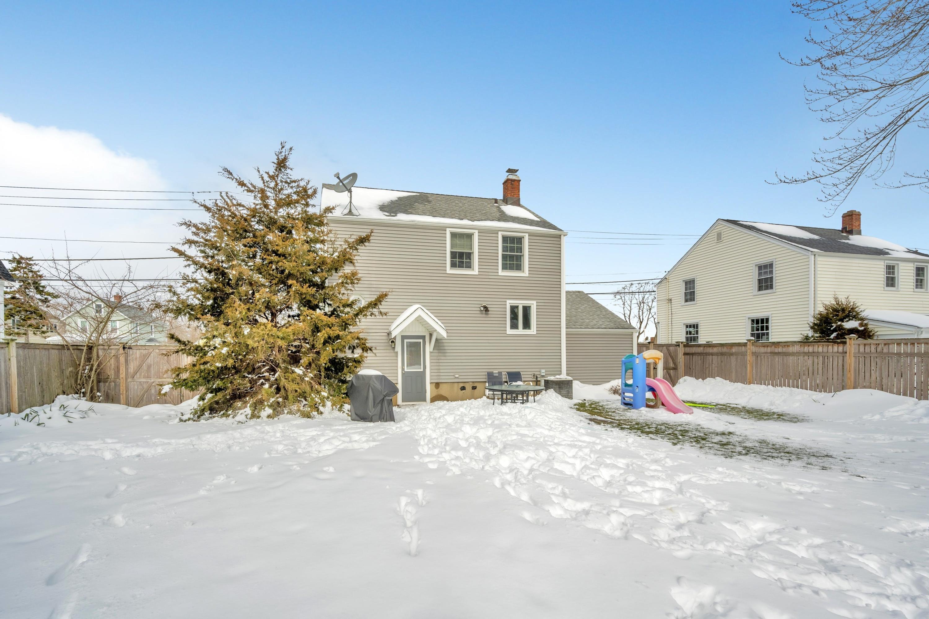 879 Oldfield Road Fairfield, CT 06824 - Photo 20 of 26 a view of a house with snow on the road