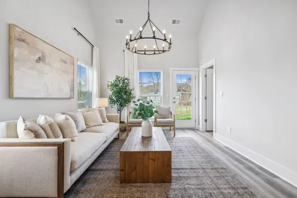 a living room with furniture a dining table with wooden floor