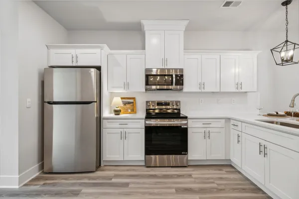 a kitchen with a refrigerator stove and microwave