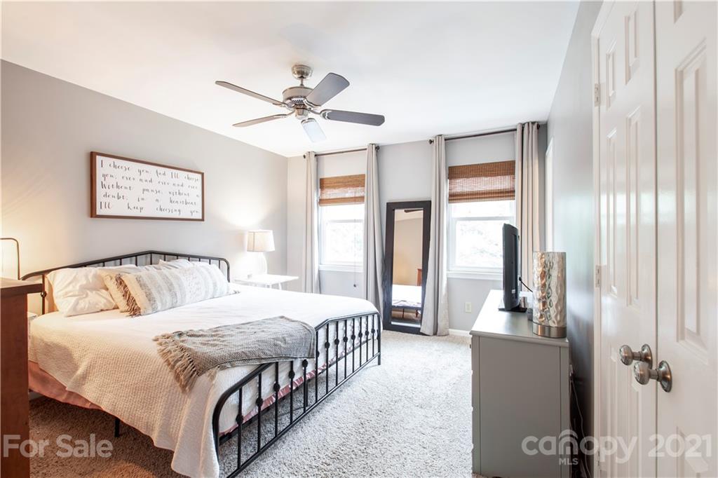 2512 Olde Whitehall Road Charlotte, NC 28273 - Photo 11 of 25 a bedroom with a large bed and a chandelier