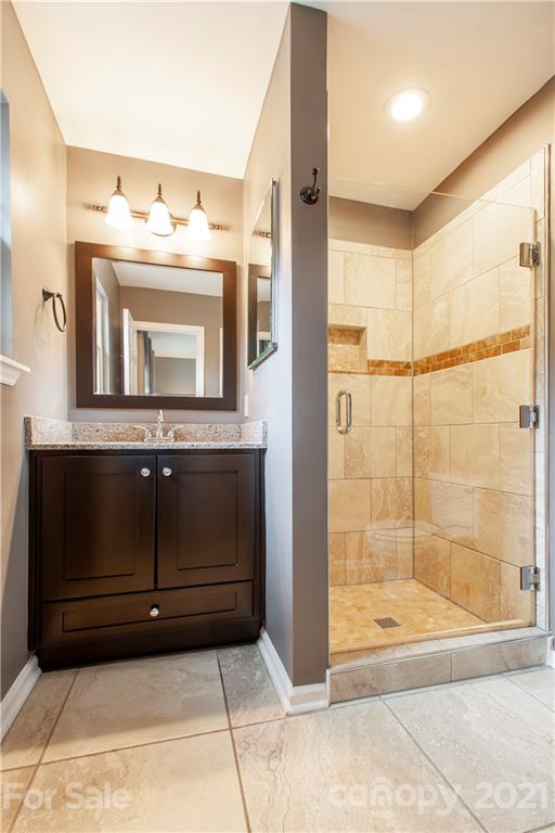 2512 Olde Whitehall Road Charlotte, NC 28273 - Photo 12 of 25 a bathroom with a mirror and a shower
