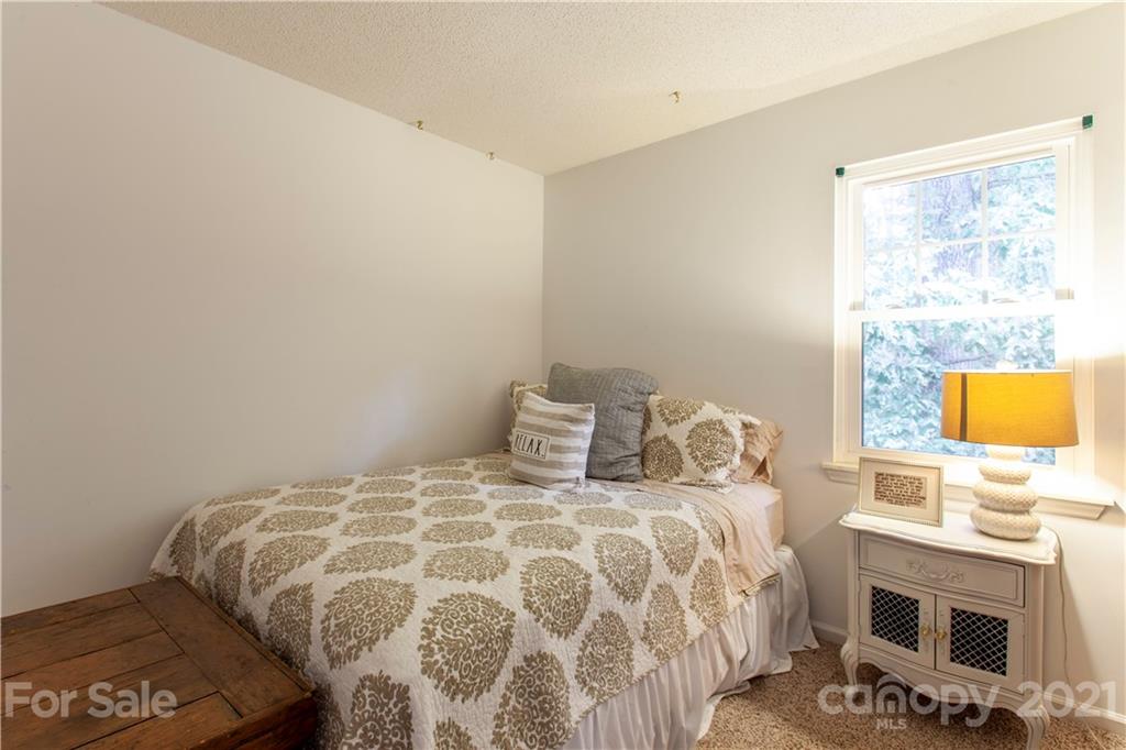2512 Olde Whitehall Road Charlotte, NC 28273 - Photo 14 of 25 a bedroom with a bed and a flat tv screen on dresser