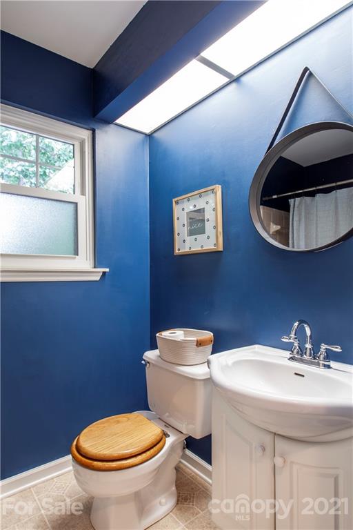 2512 Olde Whitehall Road Charlotte, NC 28273 - Photo 17 of 25 a bathroom with a toilet a sink and a window