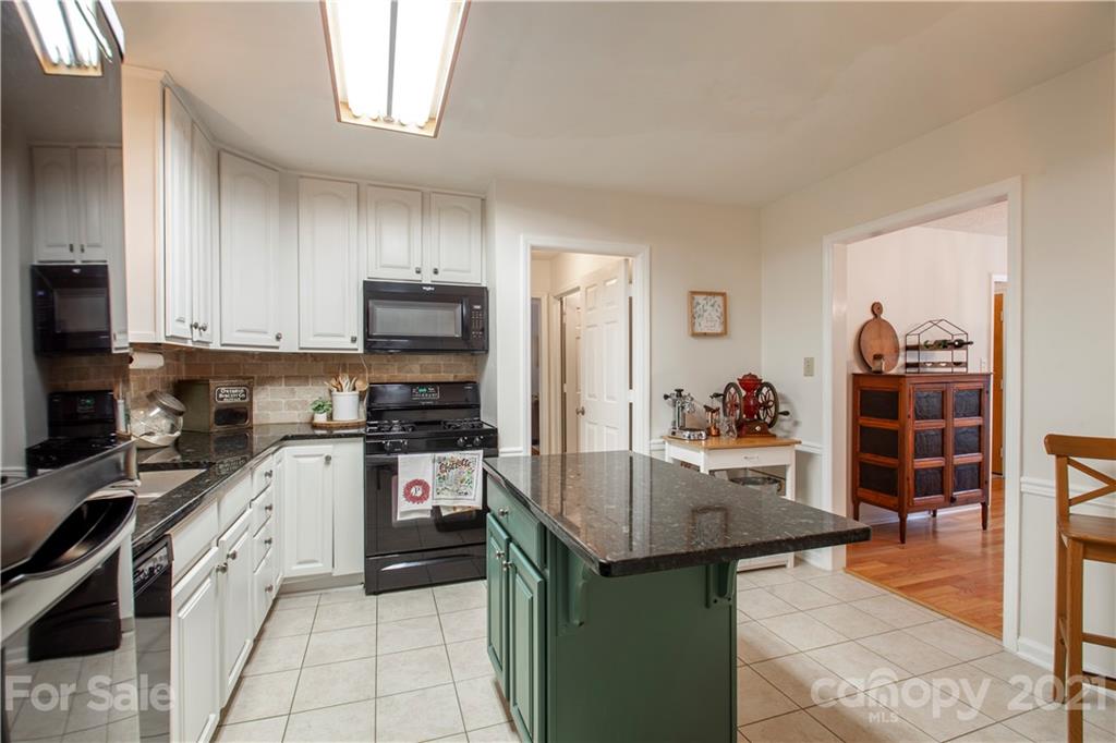 2512 Olde Whitehall Road Charlotte, NC 28273 - Photo 7 of 25 a kitchen with stainless steel appliances granite countertop a stove refrigerator and cabinets