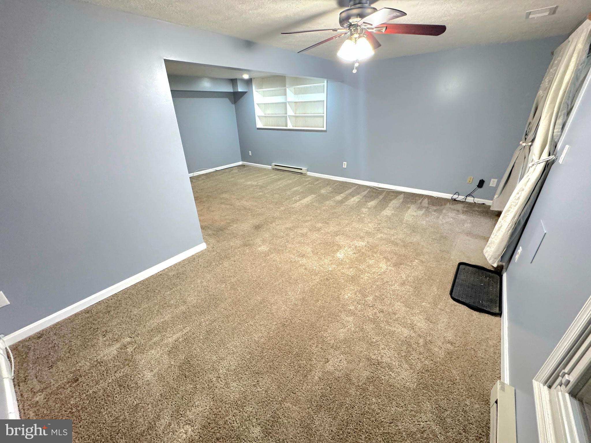 2108 Commodore Court Odenton, MD 21113 - Photo 30 of 38 en empty room with windows and ceiling fan