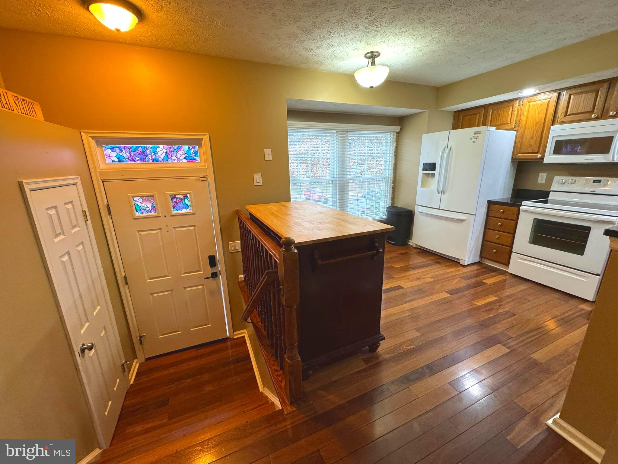 2108 Commodore Court Odenton, MD 21113 - Photo 3 of 38 a kitchen with refrigerator and wooden floor