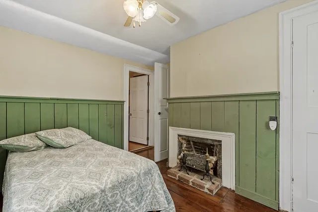 a bedroom with a bed and a fireplace