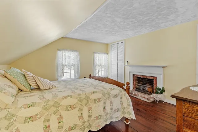 a bedroom with a bed and a fireplace