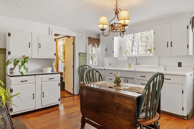a kitchen with kitchen island granite countertop a sink cabinets and stainless steel appliances