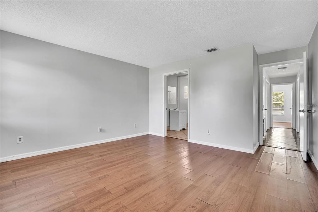10626 Deergrass Lane Orlando, FL 32821 - Photo 14 of 41 a view of an empty room with wooden floor