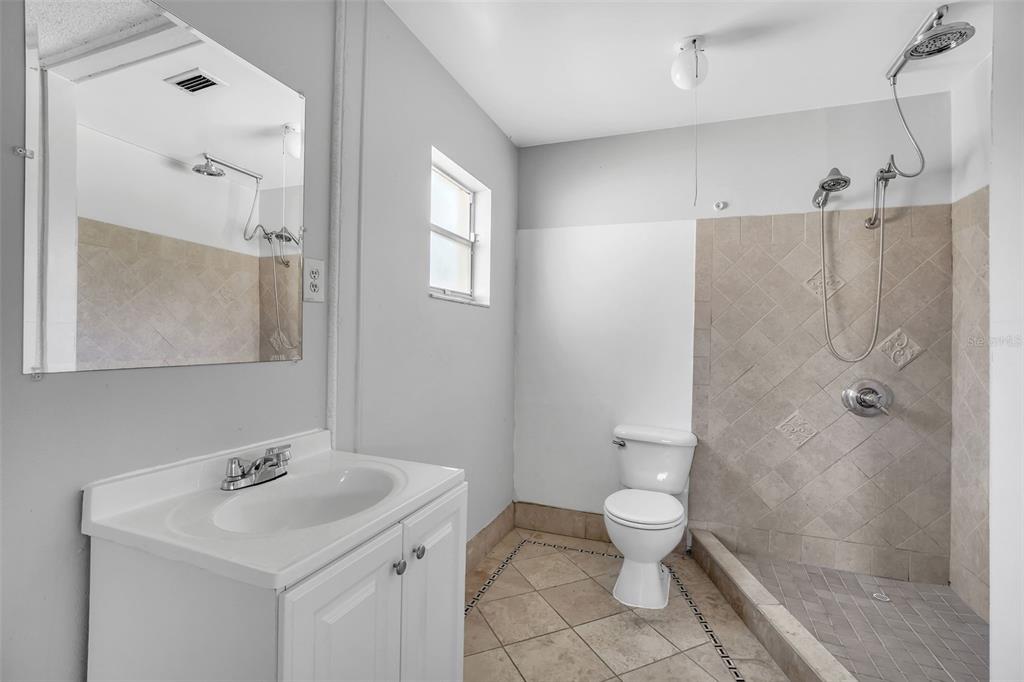 10626 Deergrass Lane Orlando, FL 32821 - Photo 17 of 41 a bathroom with a sink toilet and shower