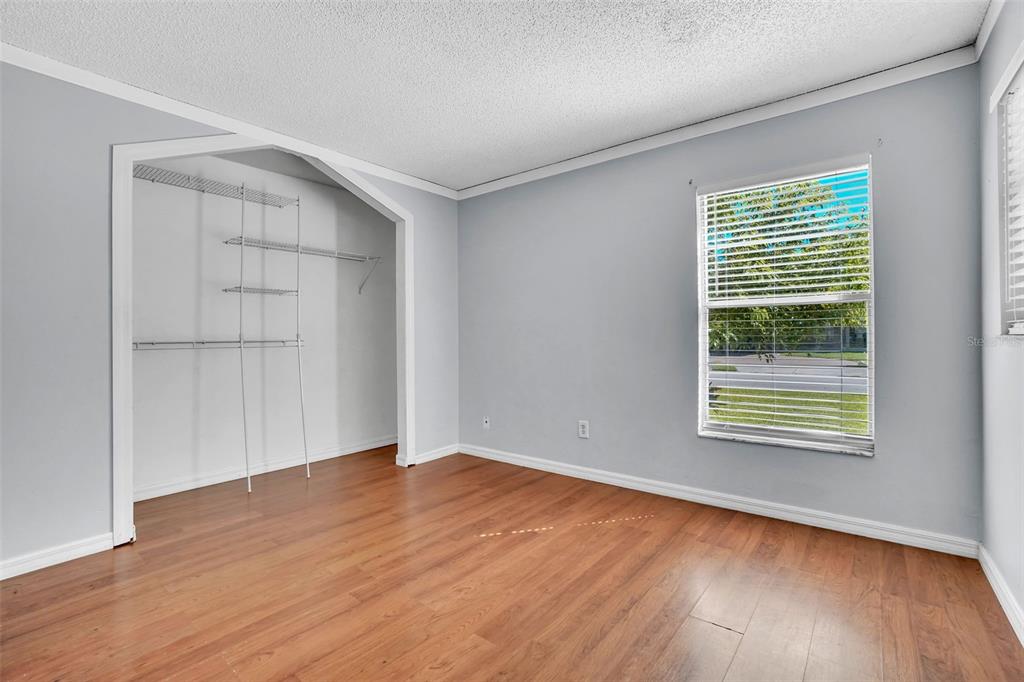10626 Deergrass Lane Orlando, FL 32821 - Photo 18 of 41 a view of an empty room with wooden floor and a window
