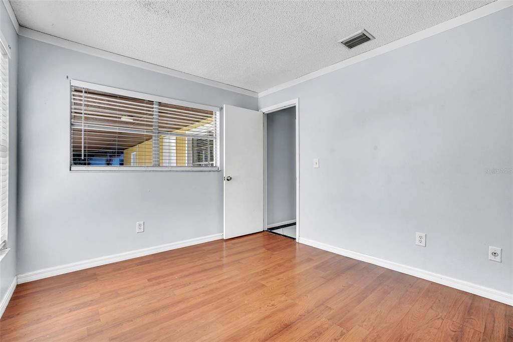 10626 Deergrass Lane Orlando, FL 32821 - Photo 20 of 41 a view of an empty room with wooden floor and a window