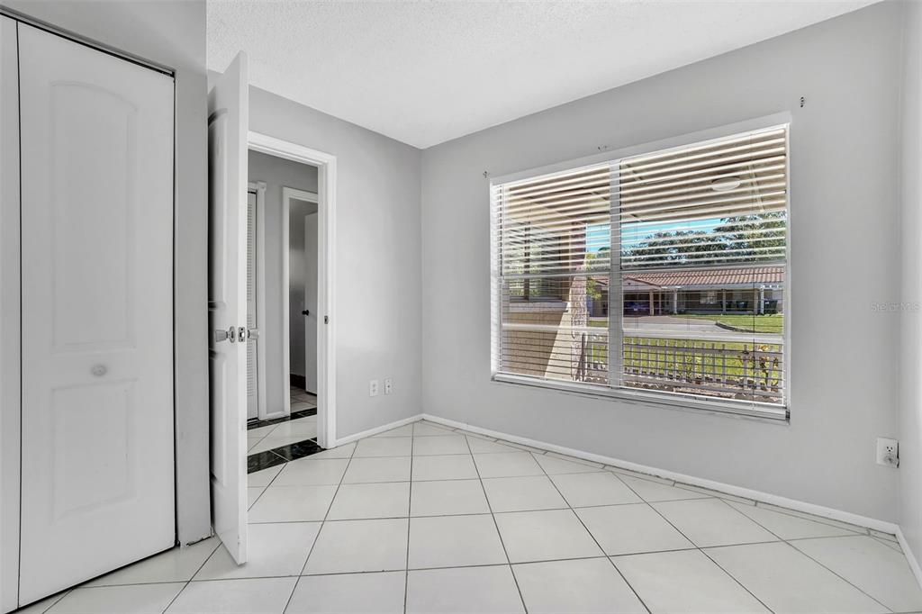 10626 Deergrass Lane Orlando, FL 32821 - Photo 23 of 41 a view of an empty room with a window and a kitchen