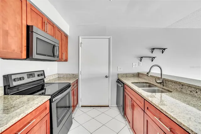 a kitchen that has a sink and a stove