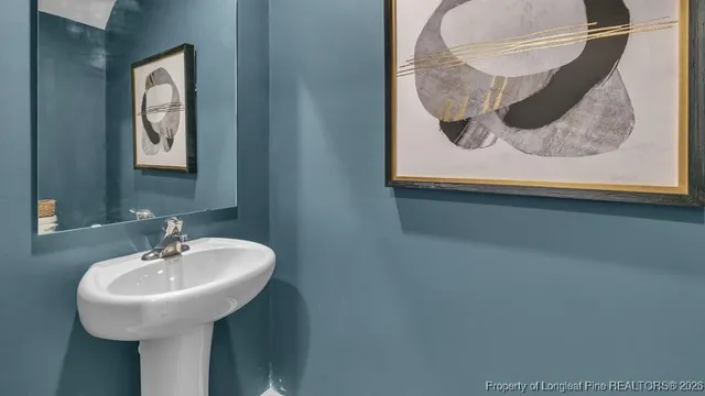 a bathroom with a sink and mirror