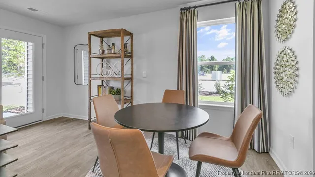 a dining room with furniture and window