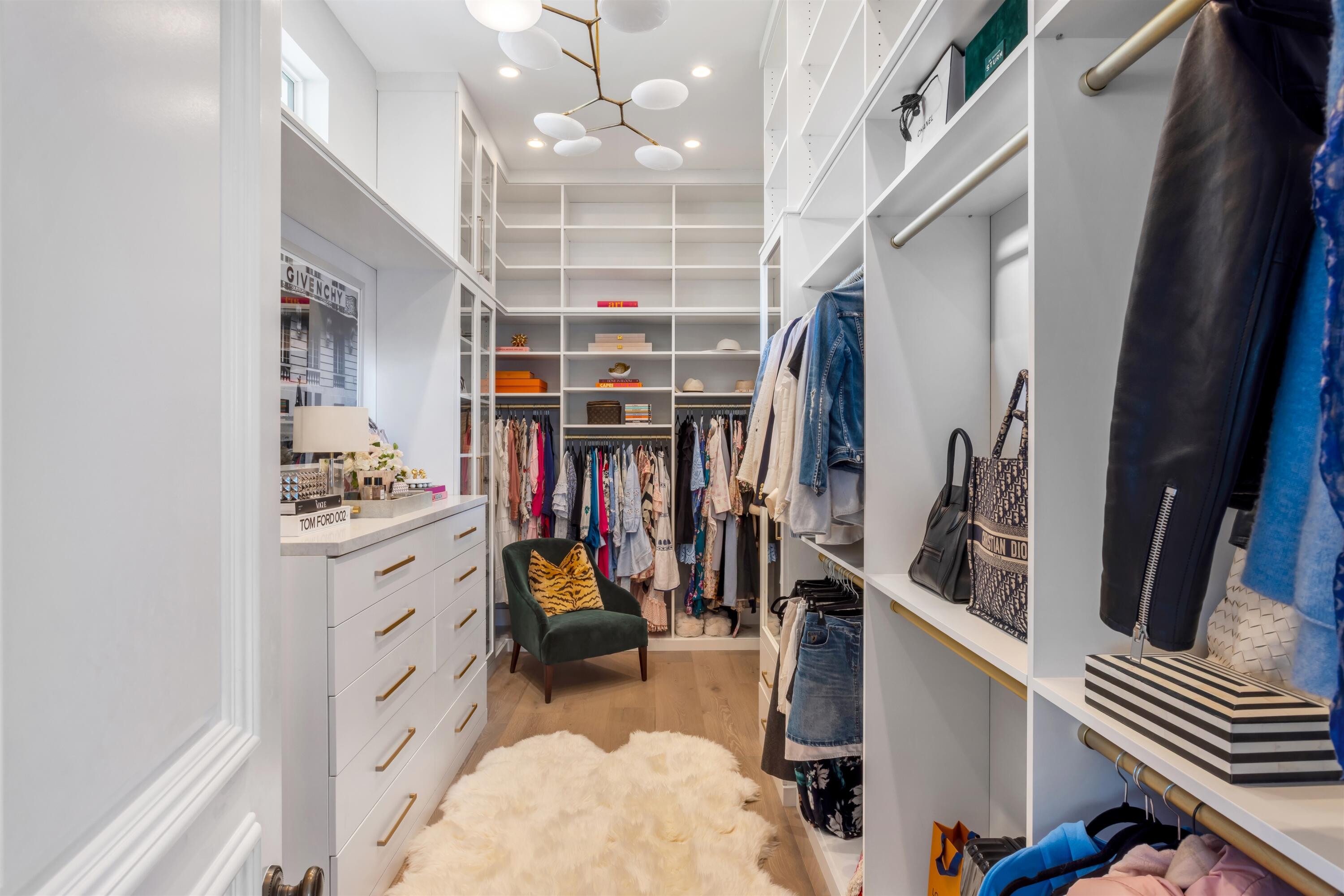 4540 Northwest 24th Avenue Boca Raton, FL 33431 - Photo 20 of 36 a view of walk in closet with clothes and shoes