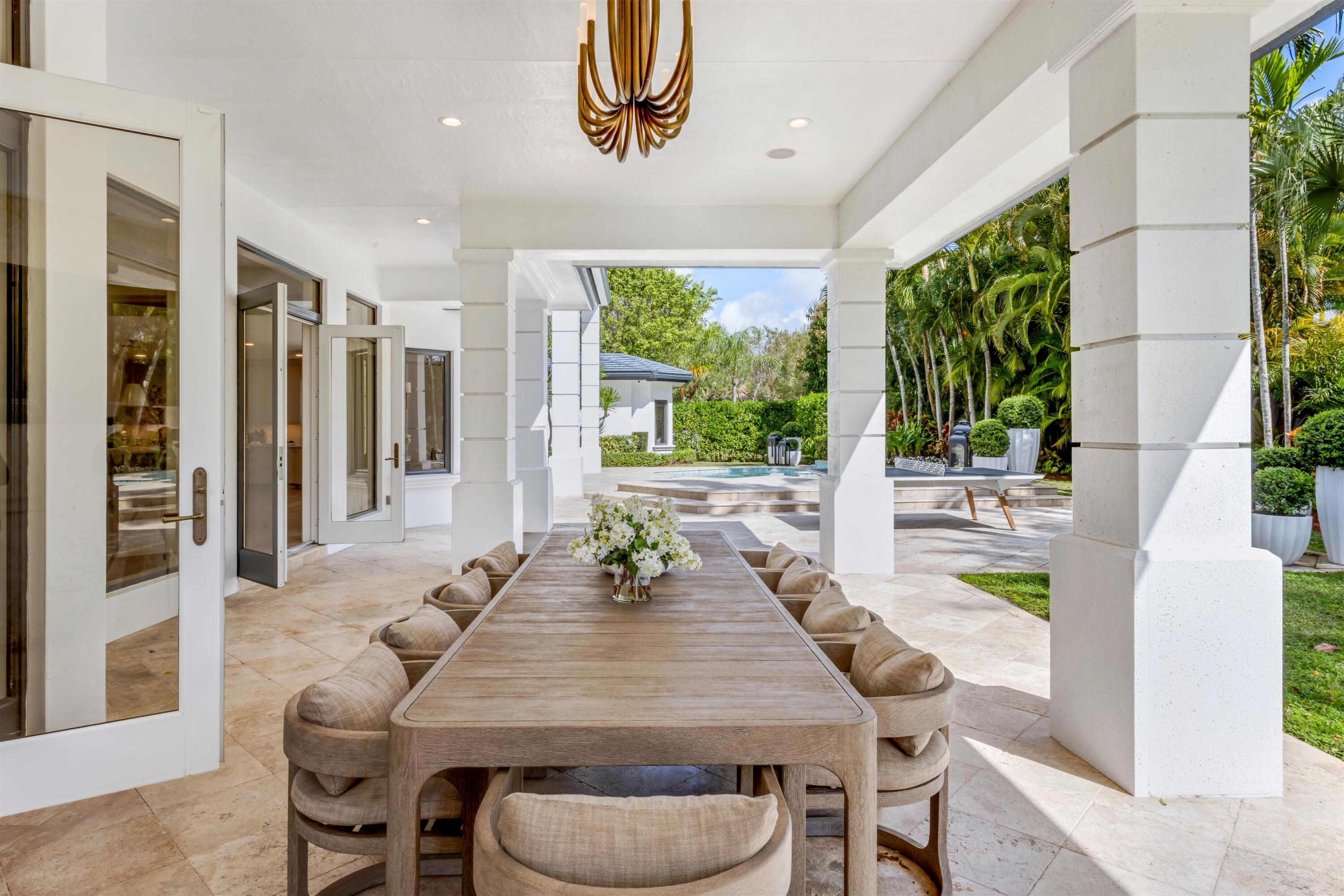 4540 Northwest 24th Avenue Boca Raton, FL 33431 - Photo 24 of 36 a dining room with furniture a rug and a painting