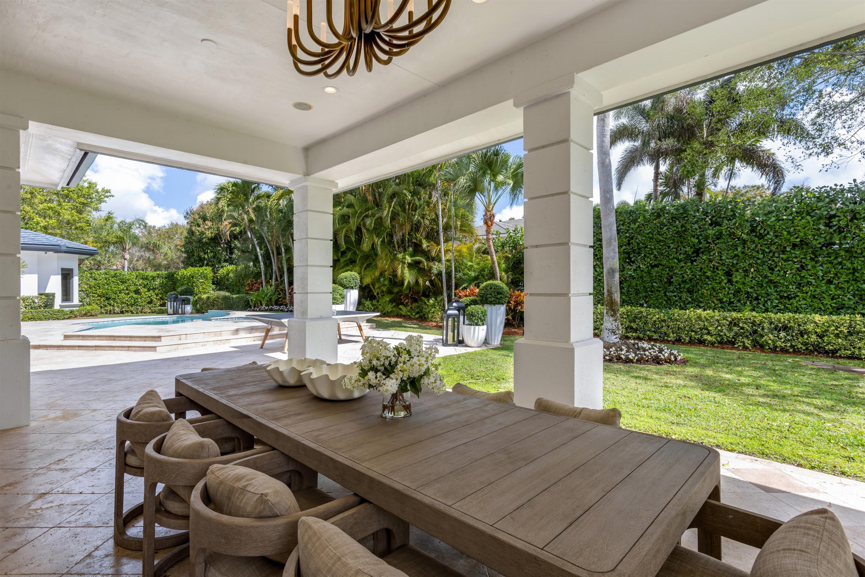 4540 Northwest 24th Avenue Boca Raton, FL 33431 - Photo 25 of 36 a view of a patio with a table chairs and a backyard