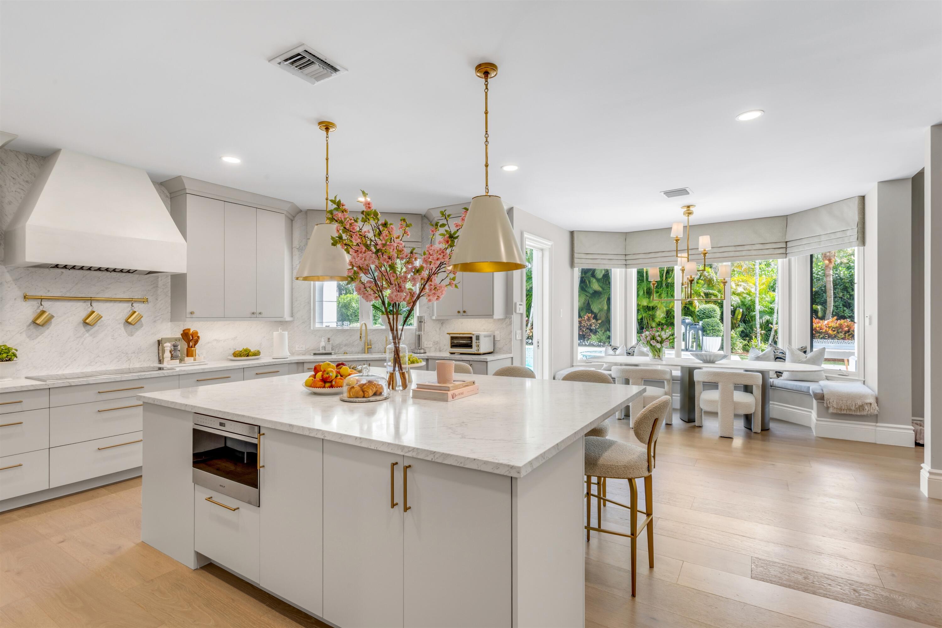 4540 Northwest 24th Avenue Boca Raton, FL 33431 - Photo 7 of 36 a kitchen that has a lot of cabinets a sink and appliances in it