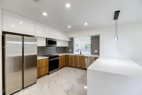 a kitchen with stainless steel appliances a sink and a window