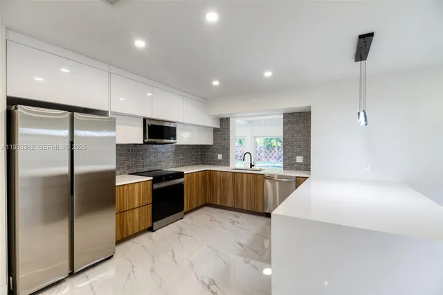 a kitchen with stainless steel appliances a sink and a window