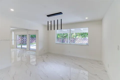 en empty room with windows and stairs