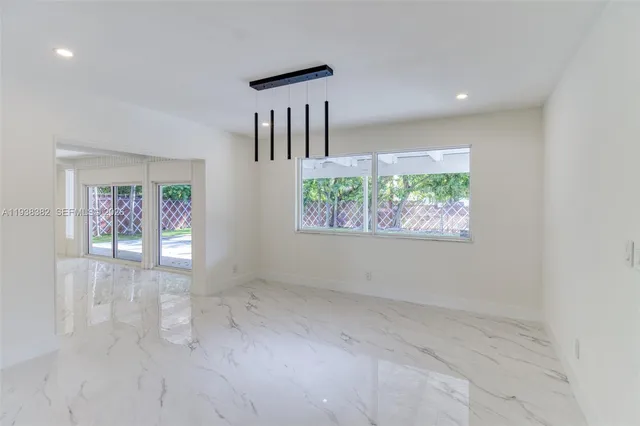 en empty room with windows and stairs