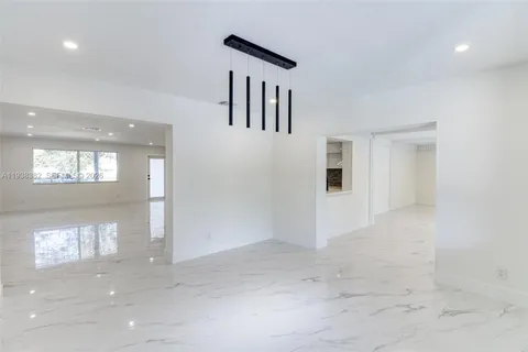 a view of hallway with a large window and doors