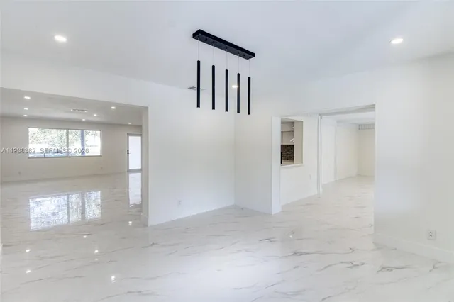 a view of hallway with a large window and doors