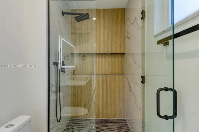 a bathroom with a shower and a sink