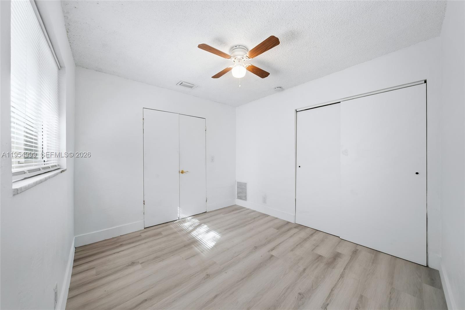 446 Southwest 4th Avenue, Unit 3 Fort Lauderdale, FL 33315 - Photo 11 of 15 a view of empty room with wooden floor and fan