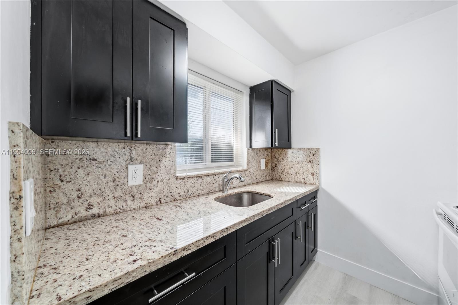 446 Southwest 4th Avenue, Unit 3 Fort Lauderdale, FL 33315 - Photo 5 of 15 a bathroom with a sink and a mirror