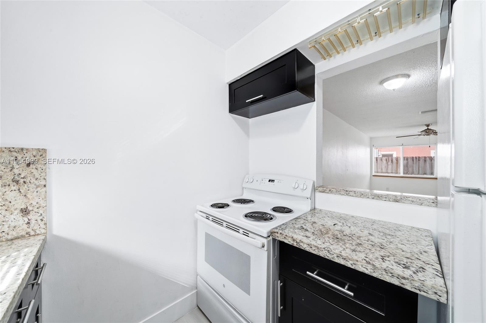 446 Southwest 4th Avenue, Unit 3 Fort Lauderdale, FL 33315 - Photo 6 of 15 a kitchen with a sink stove and microwave