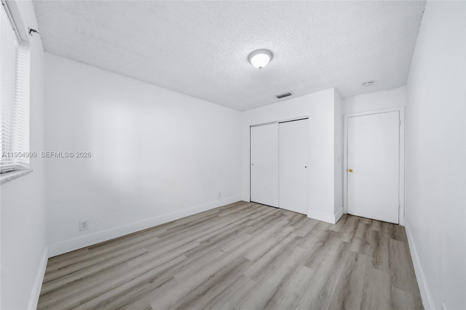 446 Southwest 4th Avenue, Unit 3 Fort Lauderdale, FL 33315 - Photo 7 of 15 a view of room with wooden floor and white walls