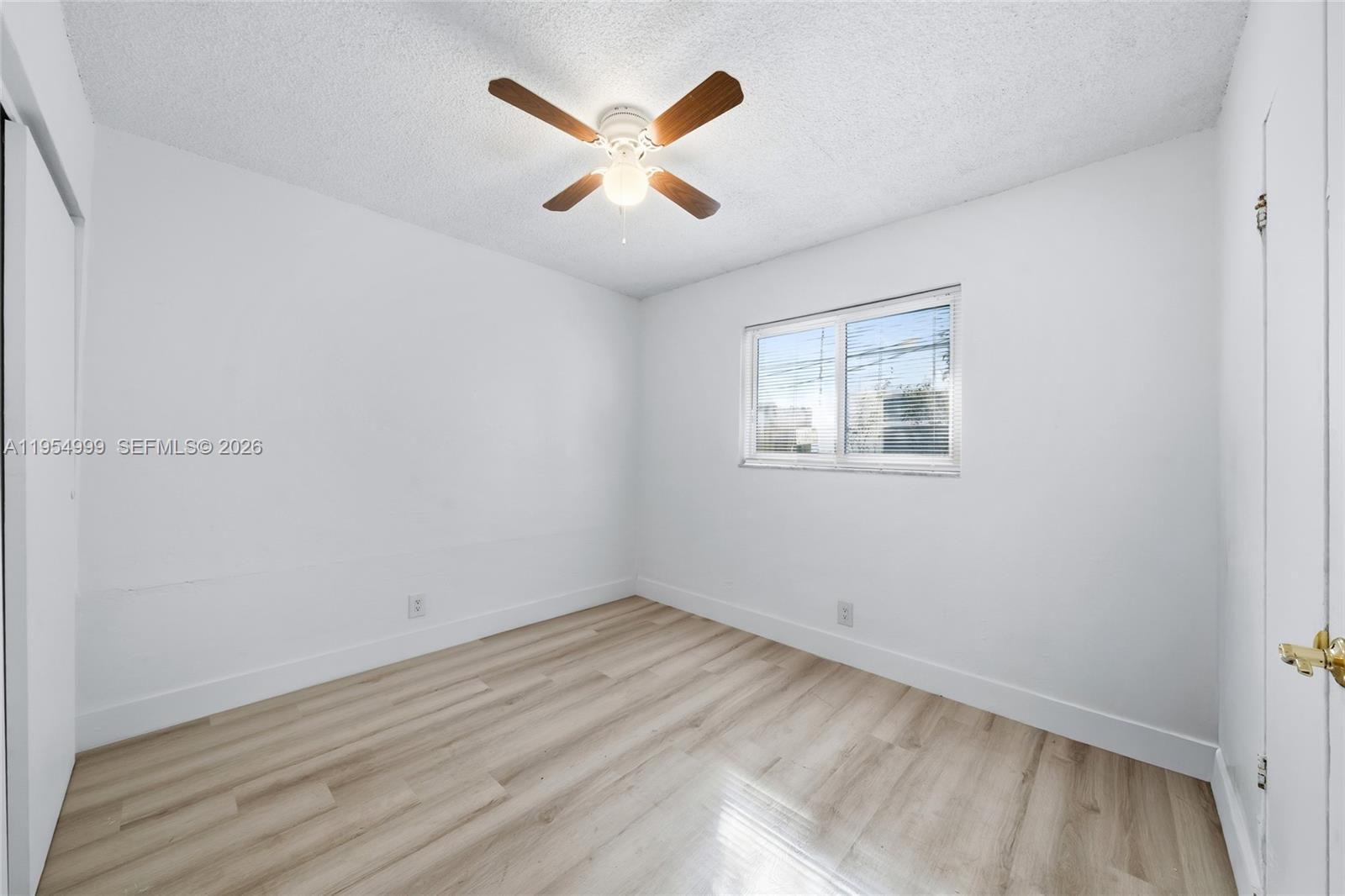 446 Southwest 4th Avenue, Unit 3 Fort Lauderdale, FL 33315 - Photo 10 of 15 an empty room with a window and a ceiling fan