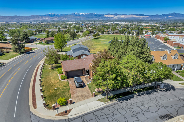 12080 Mill Ridge Circle Sandy, UT 84094 - Photo 52 of 56 Corner lot residence featuring a brick paver driveway and mature trees