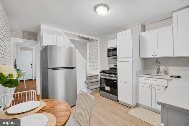 a kitchen with stainless steel appliances a refrigerator and a stove top oven
