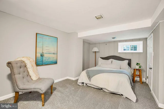 a bedroom with a bed and a chair