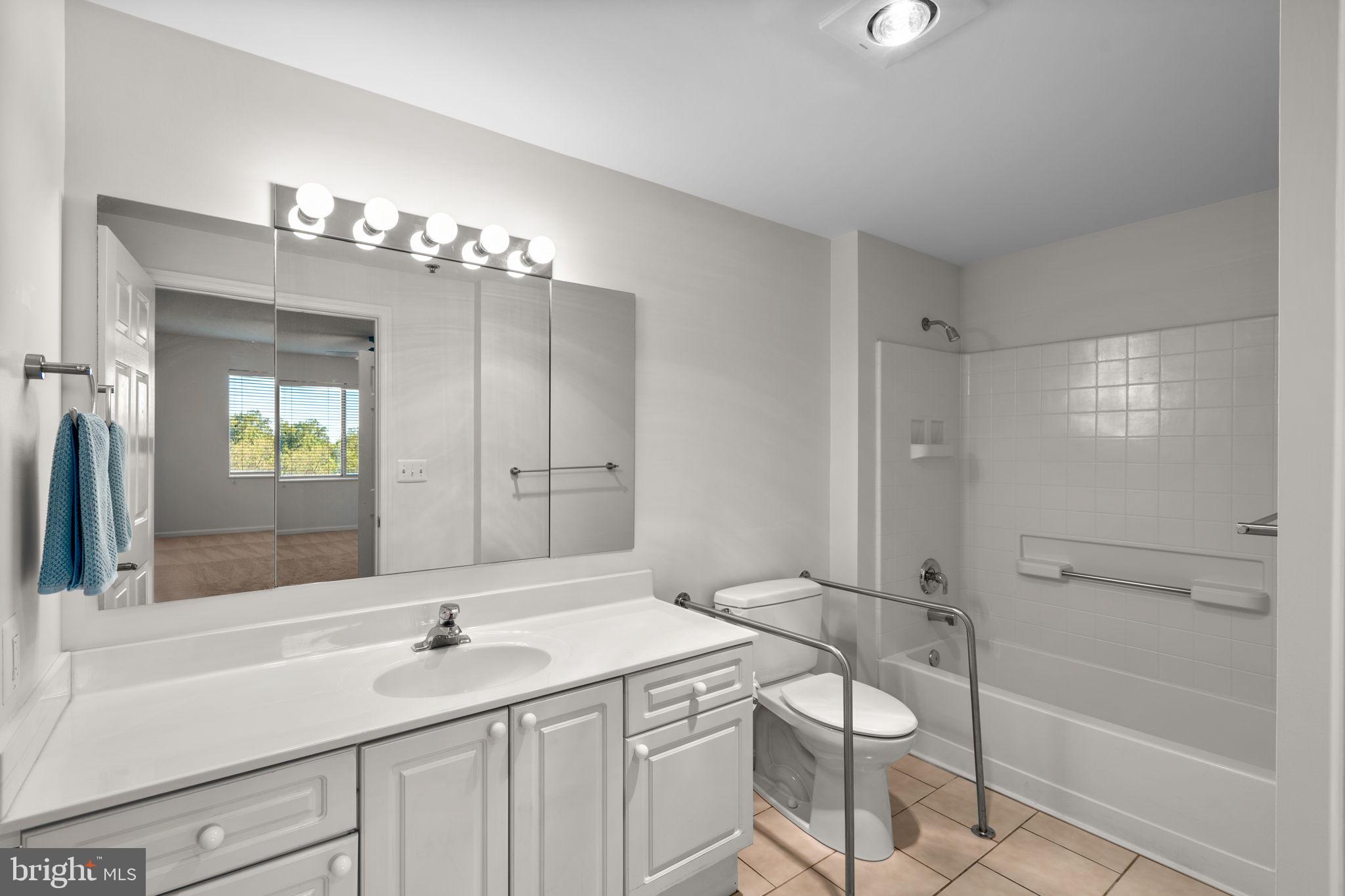 3210 North Leisure World Boulevard, Unit 1001 Silver Spring, MD 20906 - Photo 29 of 47 Primary Bathroom with tub and walk-in shower